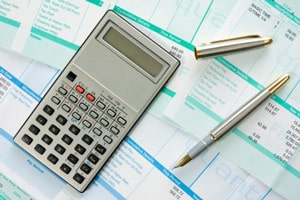 calculator, pens and labor sheets